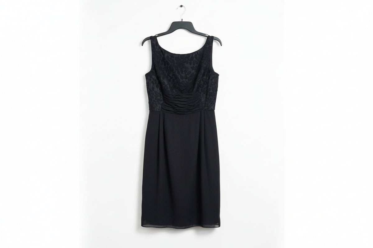 Black dress with lace detailing on a wooden surface